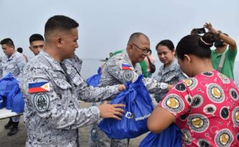 Philippine Navy personnel helped distribute relief packs to families affected by a recent oil spill.