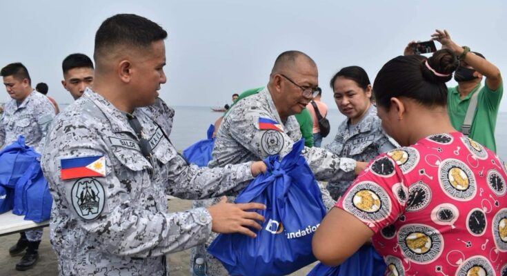 Philippine Navy personnel helped distribute relief packs to families affected by a recent oil spill.