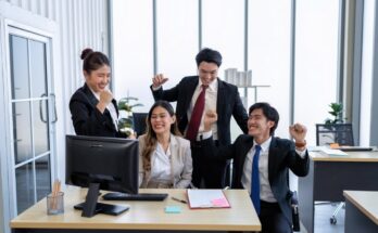 Employee on line reading good news mail from PC screen excited and happy together from their winning