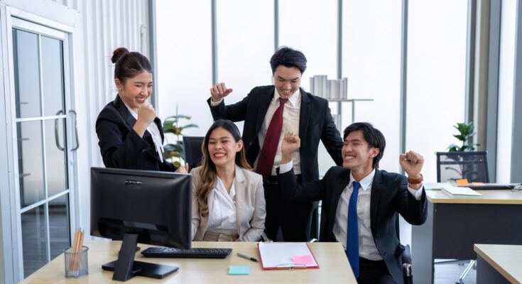 Employee on line reading good news mail from PC screen excited and happy together from their winning